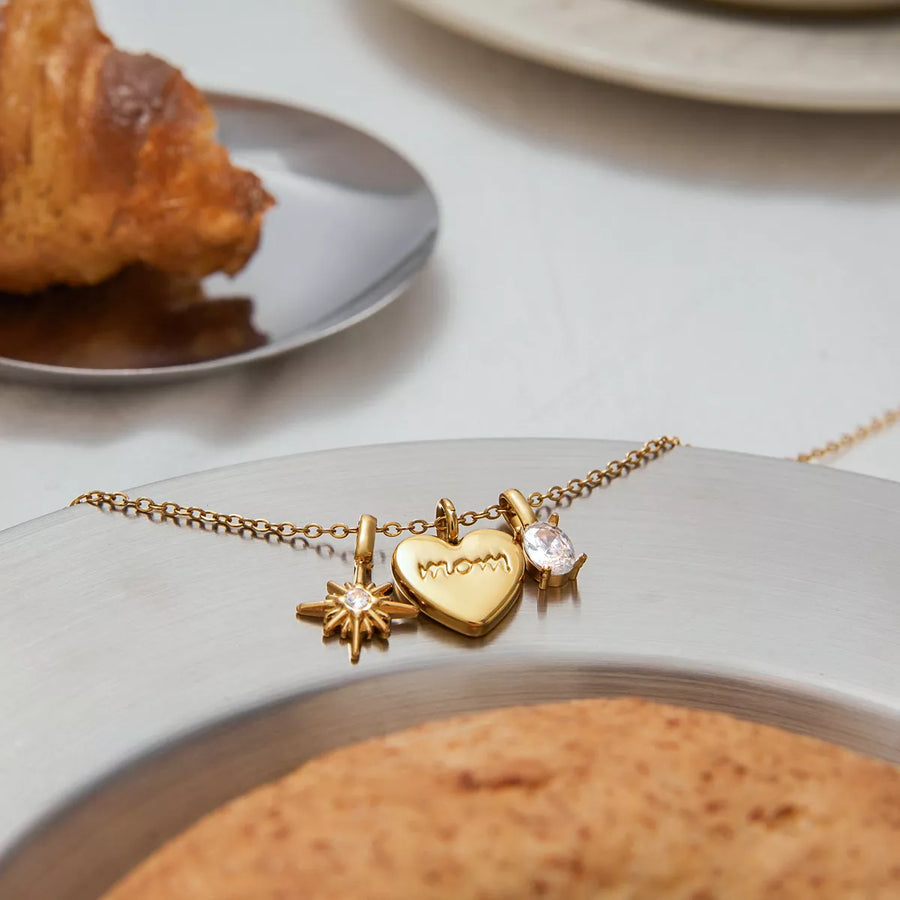 Gold heart charm necklace with mom engraving and starburst charm