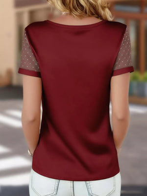 Wine red satin t-shirt with sheer polka dot sleeves and a V-neck.