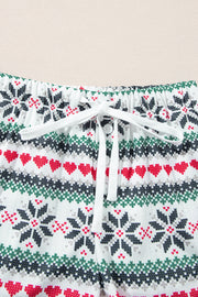 White cotton pajama shorts with festive snowflake and heart Fair Isle pattern, drawstring waist.