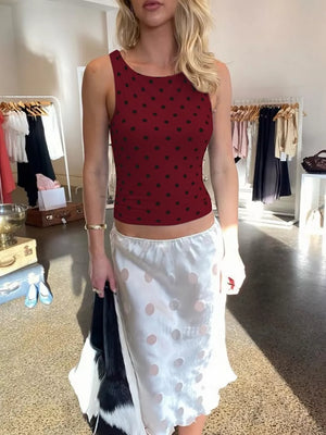 Wine red polka dot tank top with black dots, cropped length, round neck.