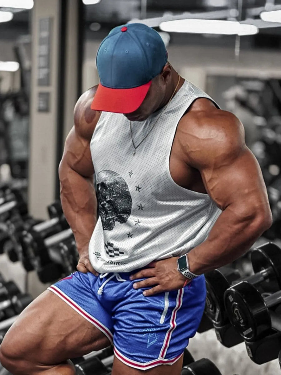 White perforated tank top with skull graphic, blue athletic shorts with white and red trim