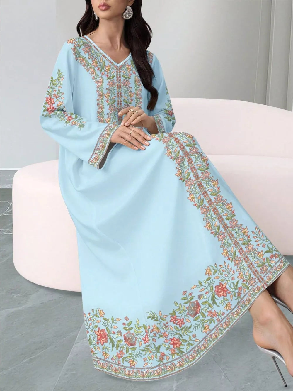 Sky blue floral maxi dress with embroidered neckline and hem, long sleeves.