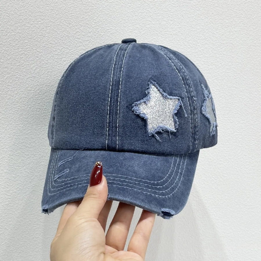 Dusty blue denim baseball cap with distressed stars and frayed details.