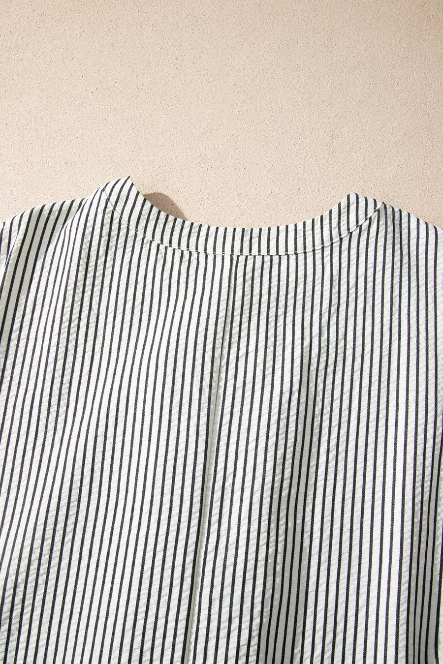 Black and white striped maternity swim dress with button-down detail and cap sleeves.
