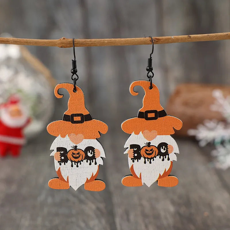 Boo Gnome Halloween earrings in tangerine with pumpkin details and black hooks.
