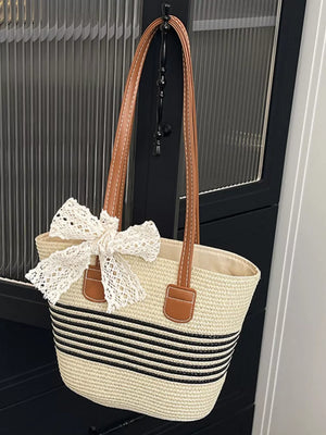 Charming straw shoulder bag with lace bow detail and black stripes
