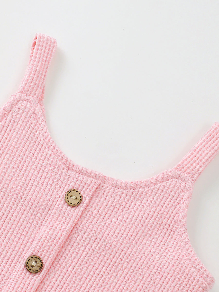 Pink waffle knit tank top with wooden buttons, part of a baby outfit set.