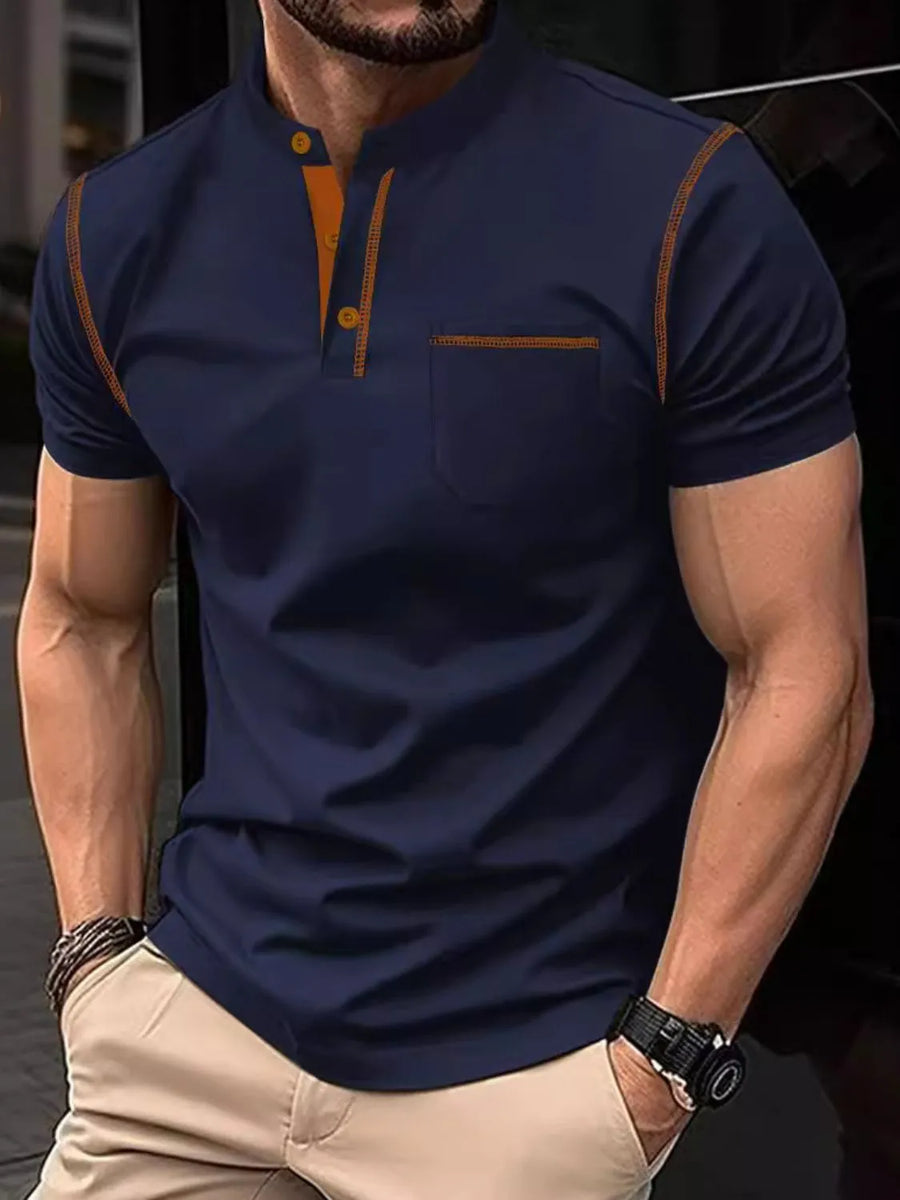 Navy polo shirt with contrast orange stitching, mandarin collar, and chest pocket.