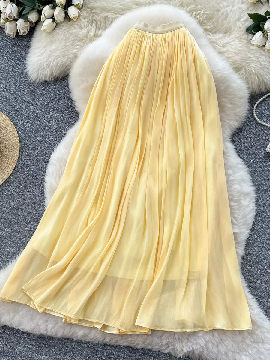 Yellow pleated maxi skirt with a flowy, airy design and a comfortable elastic waistband.