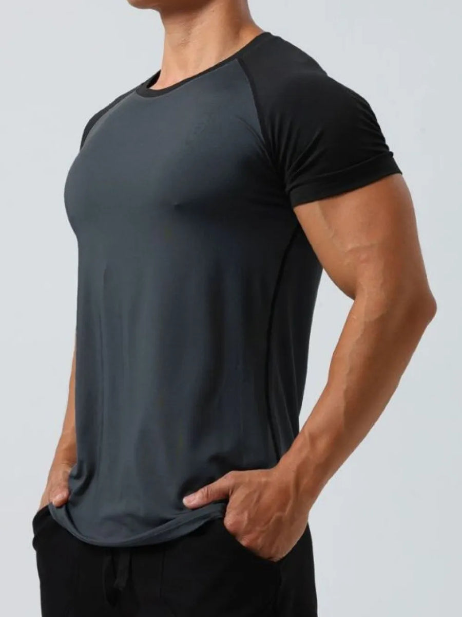 Raglan sleeve performance tee in gray with black sleeves and crew neck.