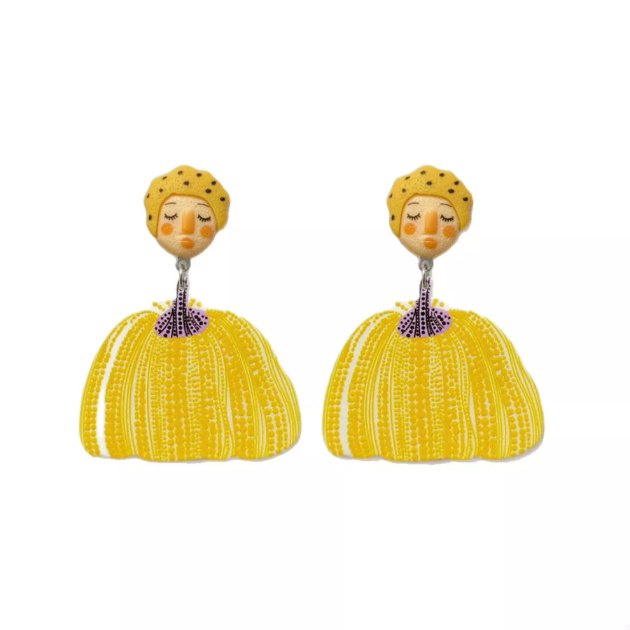 Yellow whimsical pumpkin girl dangle earrings with dotted hats and textured skirts.