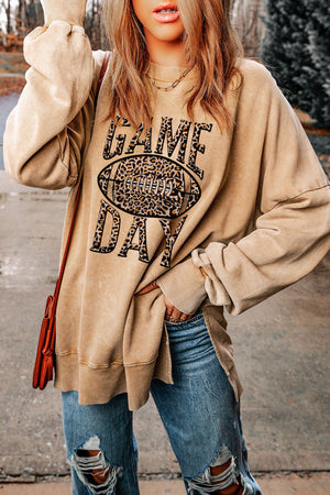 Khaki sweatshirt with leopard print football graphic and "GAME DAY" text, crew neck, long sleeves.