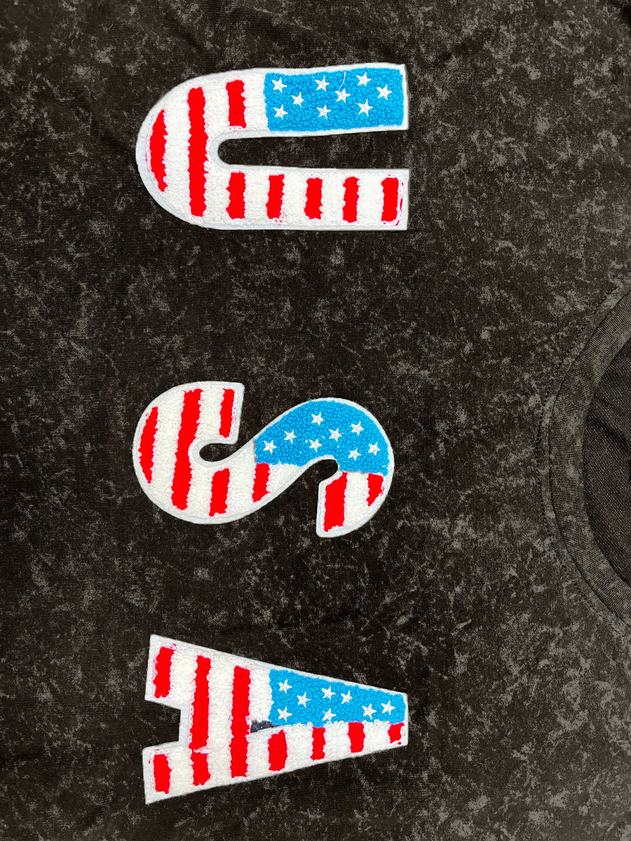 Black t-shirt with embroidered USA flag letters