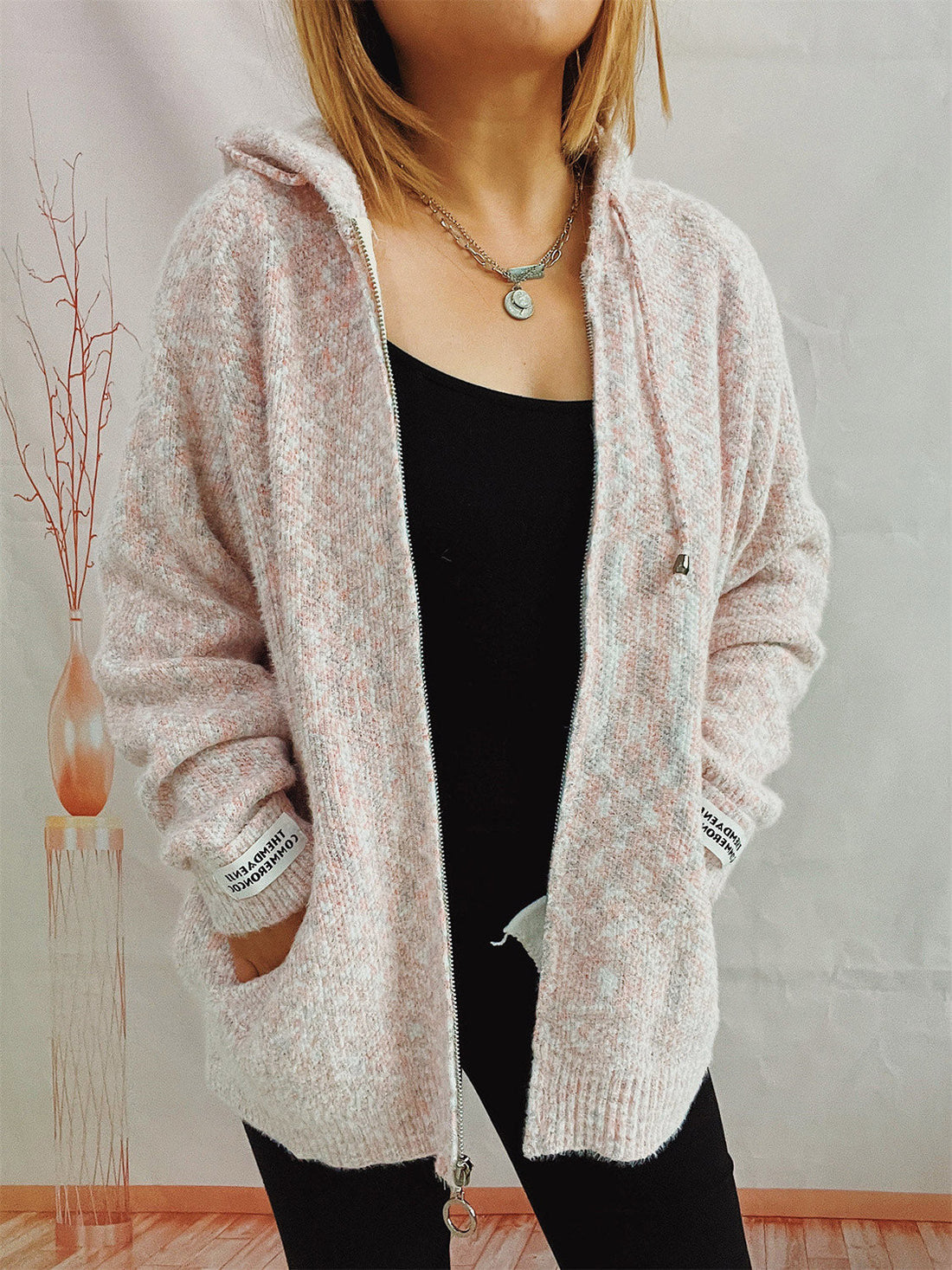 Speckled knit relaxed zip-up hoodie in Blush Pink with a silver zipper and drawstring hood.