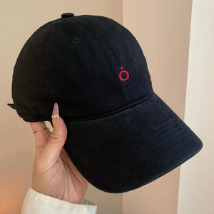 Black cotton baseball cap with curved brim and red embroidered logo detail.