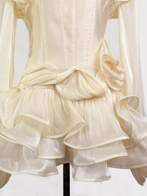 Elegant white ruffled mini dress with corset waist and long sleeves.