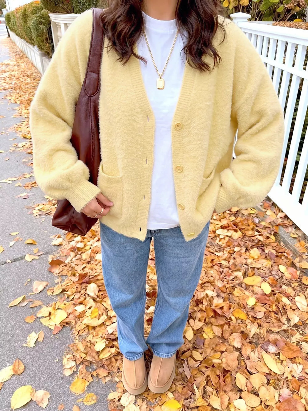cardigan in pale yellow featuring buttoned and relaxed fit
