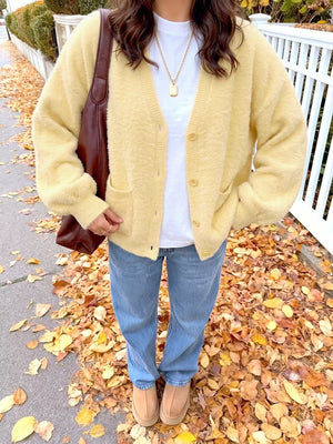 cardigan in pale yellow featuring buttoned and relaxed fit