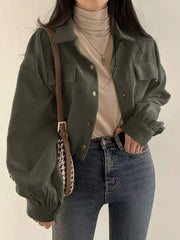 Black trucker jacket with chest flap pockets and long sleeve