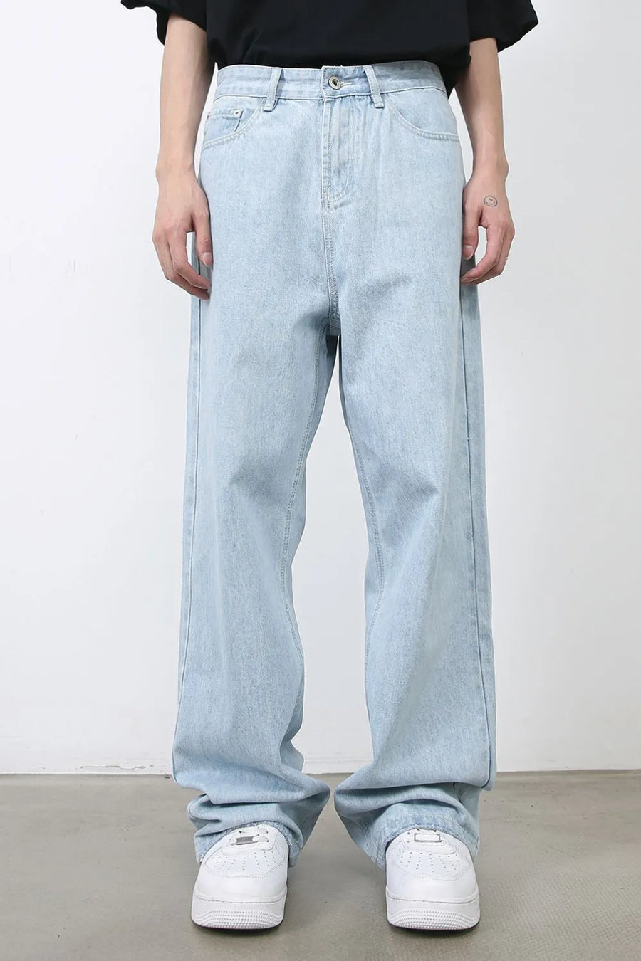 Baggy light blue denim palazzo jeans with a relaxed fit and button fly.