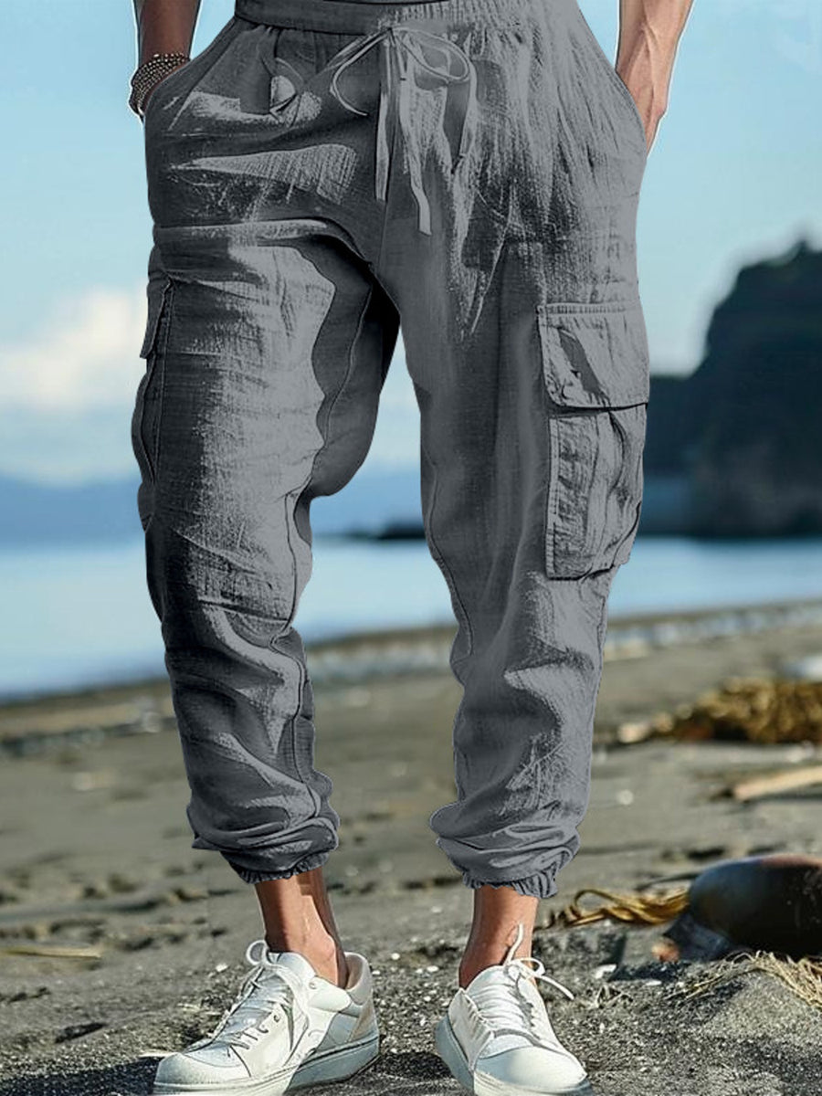 Gray cargo pants with drawstring waist and cuffed ankles, featuring side pockets.