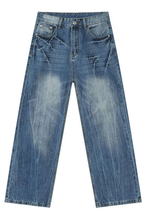 Wide-leg distressed denim jeans in vintage wash medium blue with faded details.