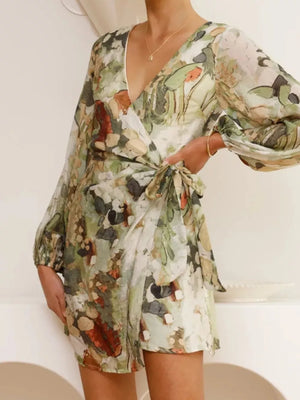 V-neck tie waist dress with abstract green and orange floral print, balloon sleeves.