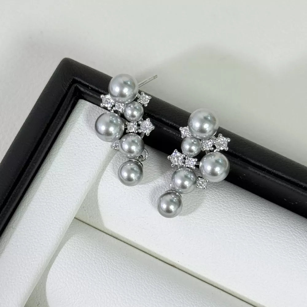 Light gray pearl and zircon cluster earrings with dangling pearls.