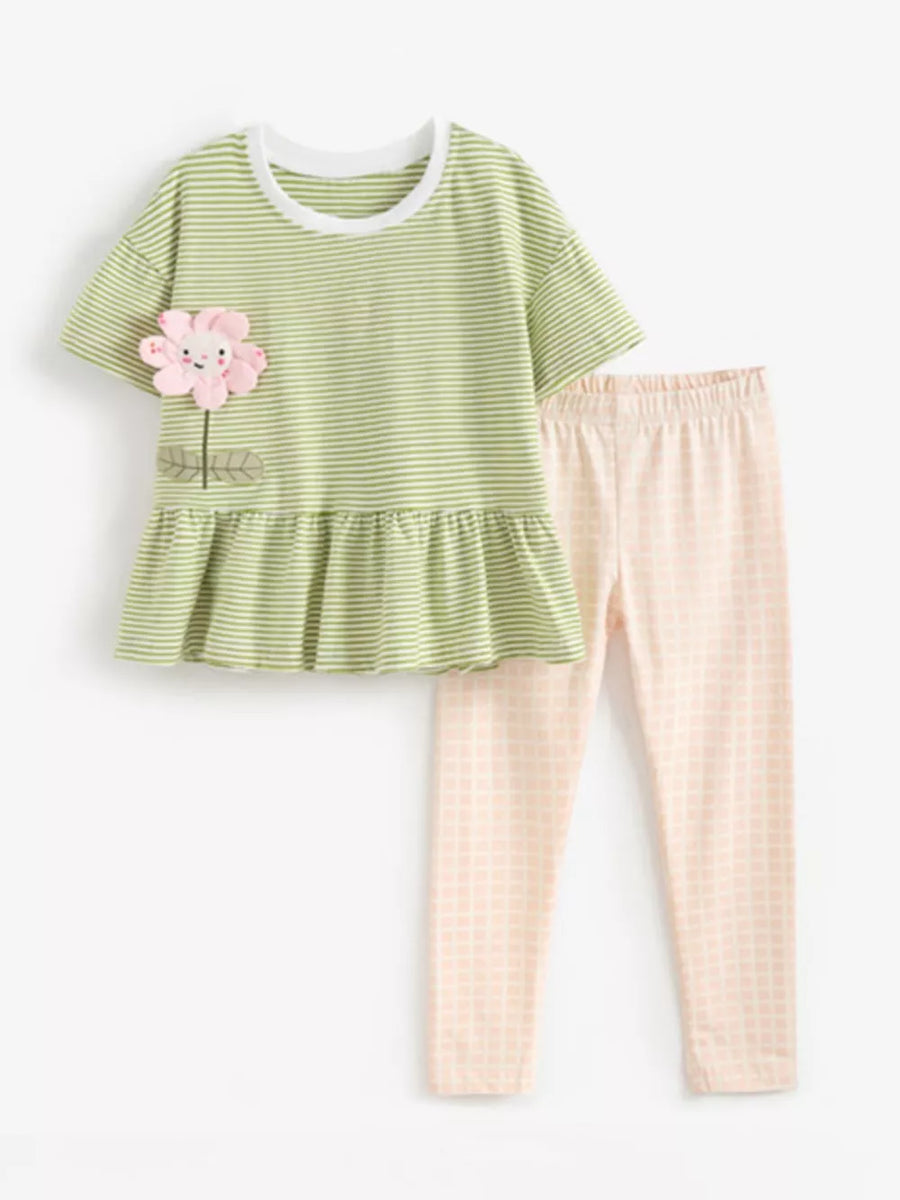 Green striped peplum top with flower applique and pink checkered leggings.