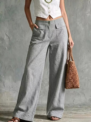 Grey linen wide-leg pants with dual flap pockets and a button closure.