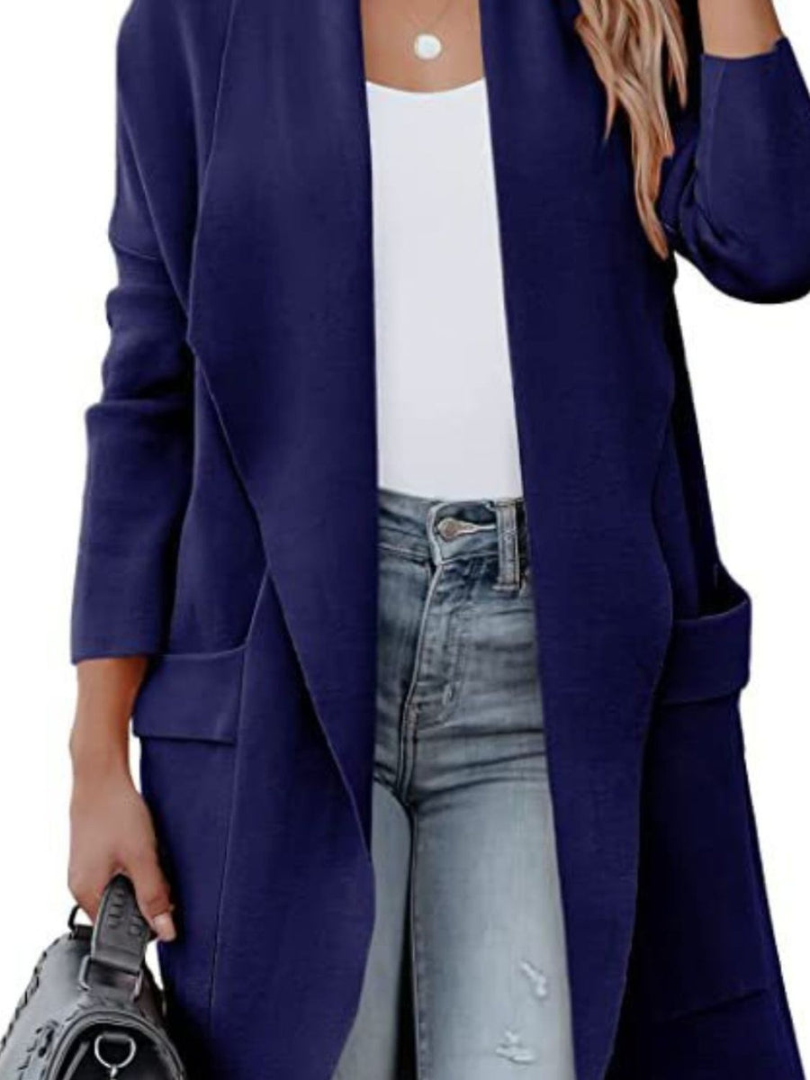 Dark blue open-front duster cardigan with pockets and a draped neckline, styled with jeans.