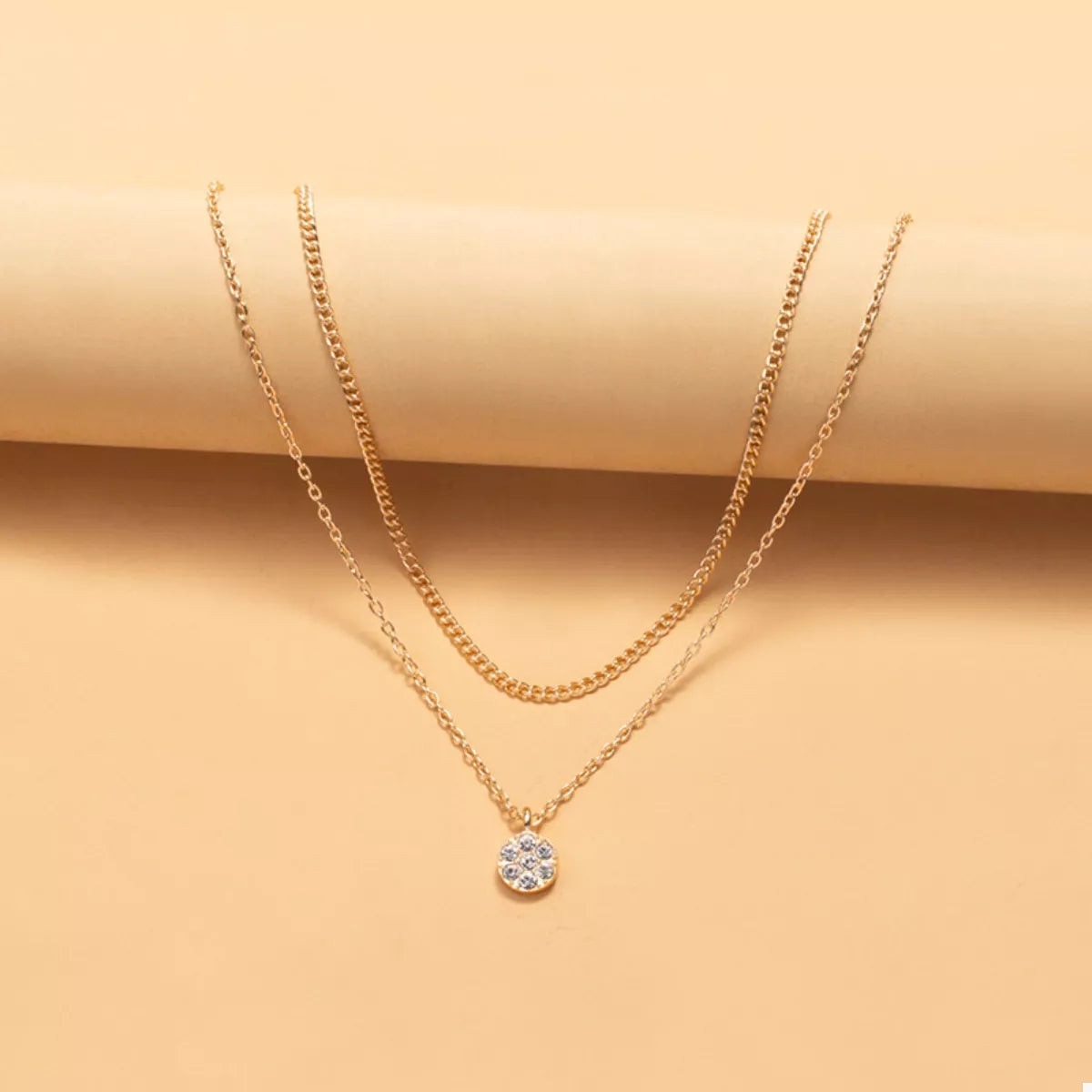 Gold double layered pendant necklace with small crystal charm