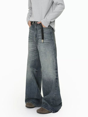 Men's wide leg denim jeans in blue wash with a relaxed fit and gradient fade.