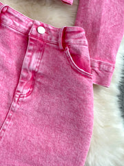 Pink acid wash denim jacket and skirt set with button details and pocket.