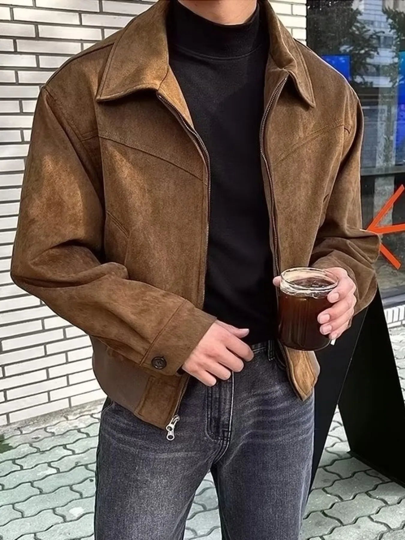 Brown suede zip-up casual jacket with a collar and button cuffs, worn by a man.