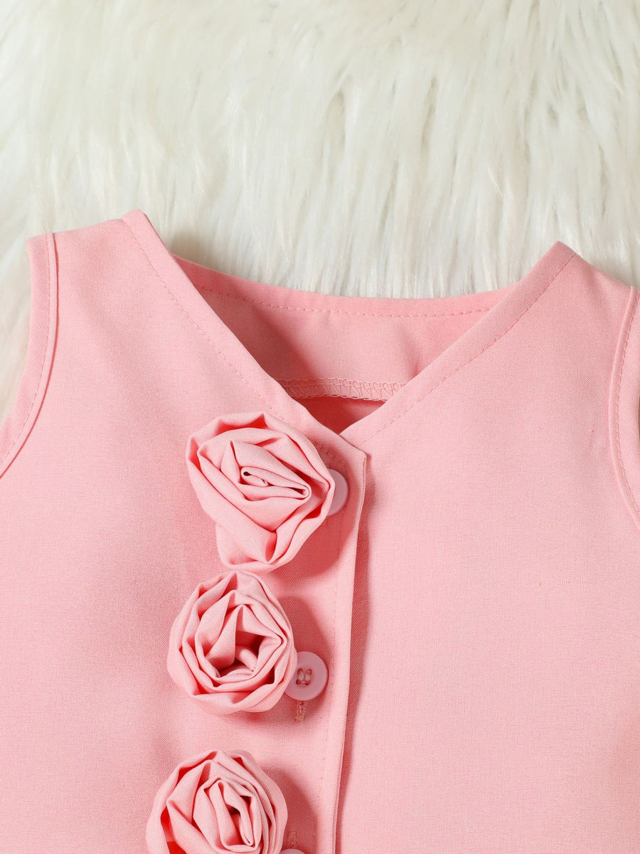Pink sleeveless v-neck top with rose appliques and buttons