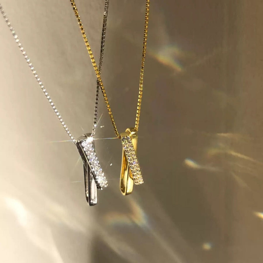 Sterling silver and gold necklaces with crossover zircon pendants on box chains