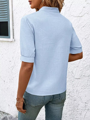 Blue embroidered notched blouse with cuffed sleeves and a stand collar.