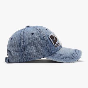 Distressed denim baseball cap in light blue with a patch and frayed brim.
