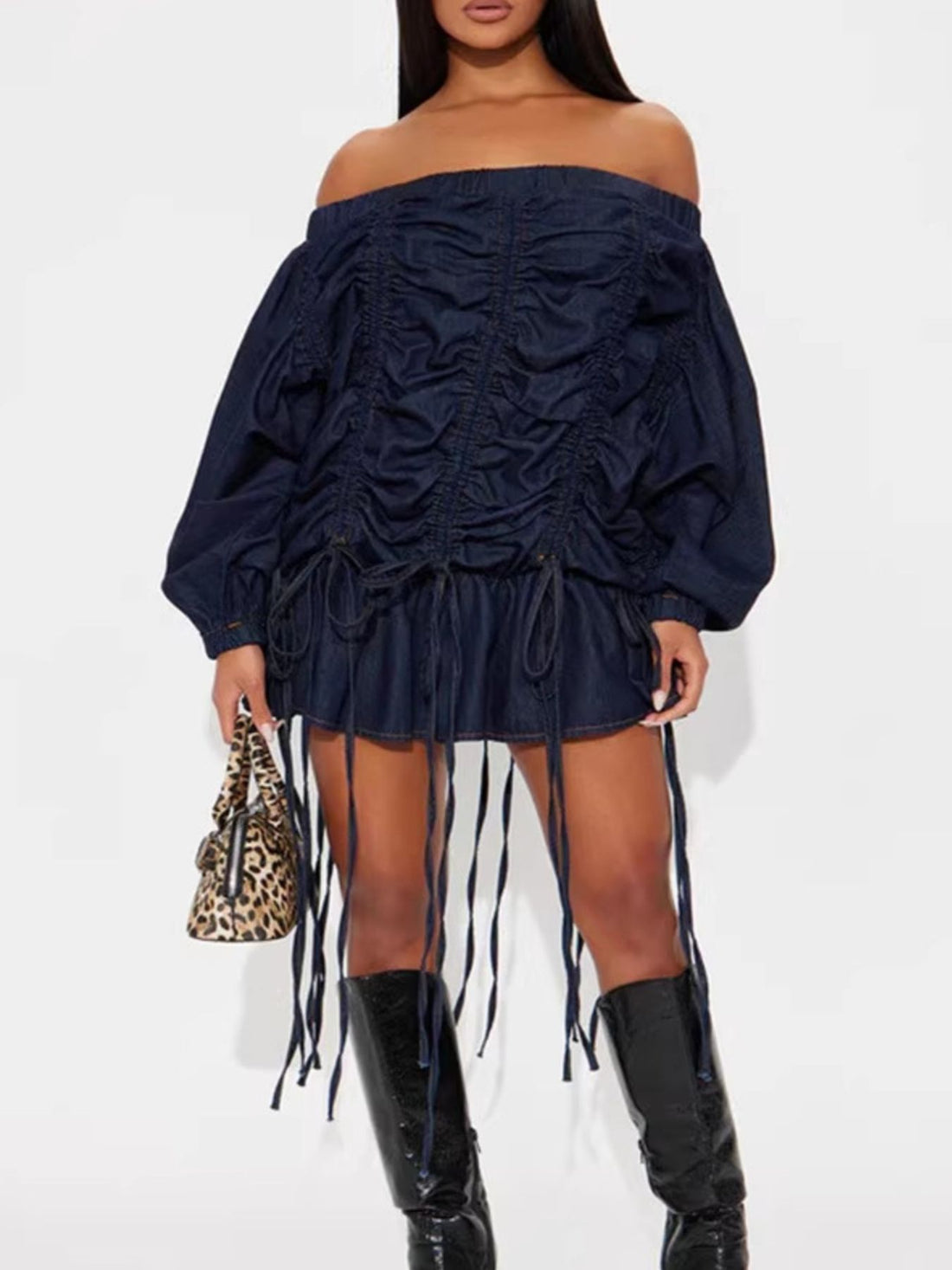 Dark navy denim off-the-shoulder dress with ruched front, balloon sleeves, and fringe hem.