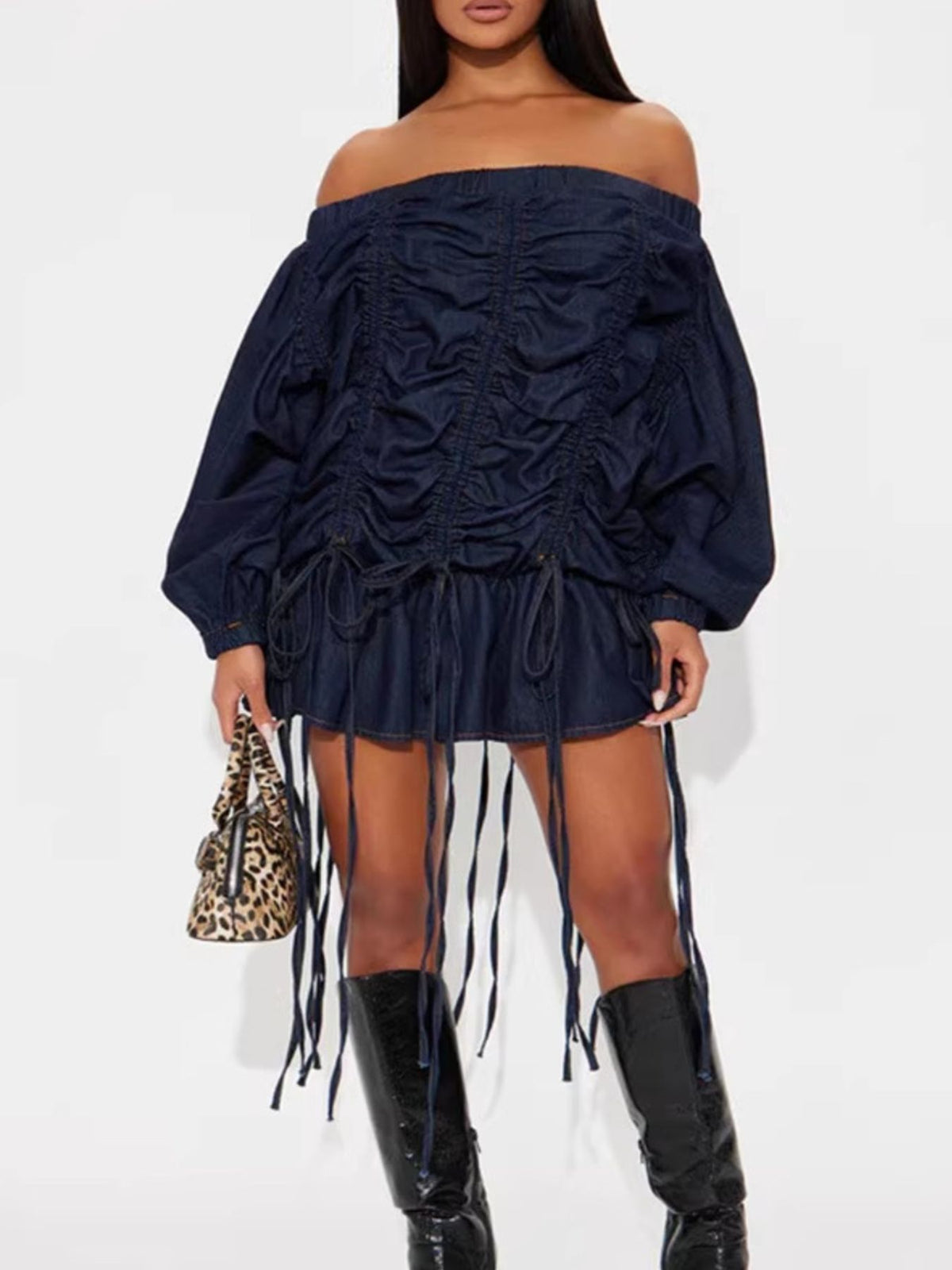 Dark navy denim off-the-shoulder dress with ruched front, balloon sleeves, and fringe hem.
