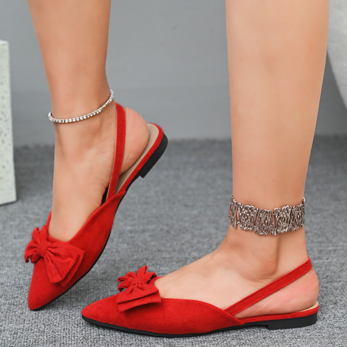 Red slingback flats with bow detail and pointed toe, casual and chic.