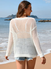 White open-knit beach sweater with ribbed trim and long sleeves.