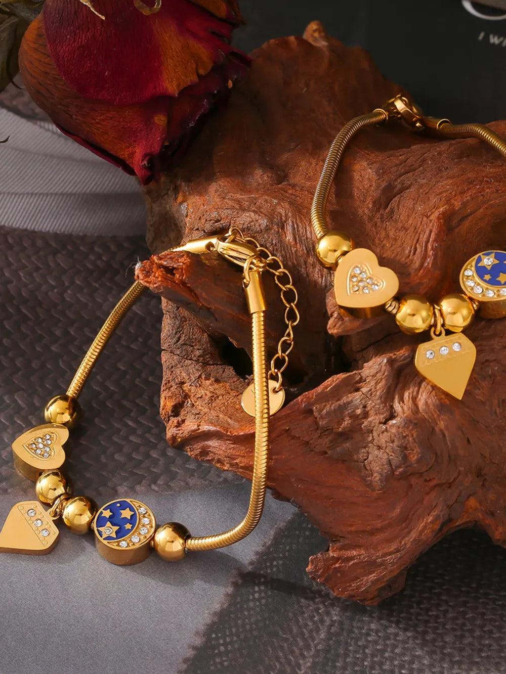 Gold celestial charm bracelet with diamond accent hearts and moon charms
