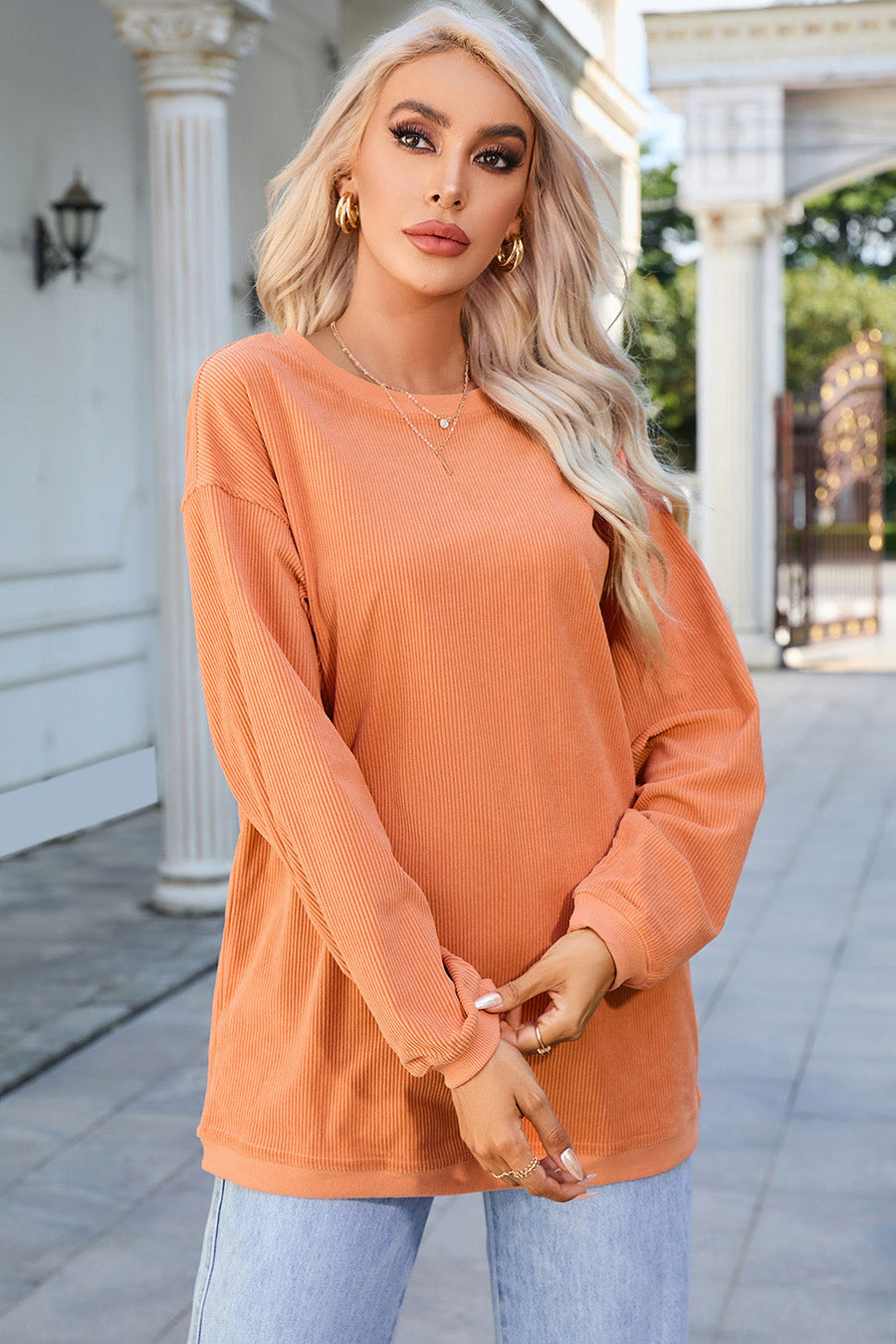 Orange corduroy relaxed fit sweatshirt with crew neck and long sleeves.