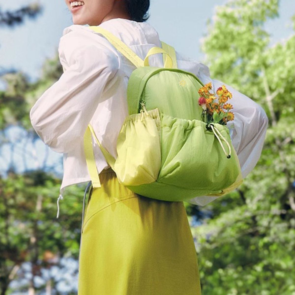 Mini lightweight nylon drawstring backpack in Gum Leaf green with yellow accents and flowers in front pocket