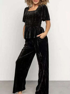 Black velvet two-piece set with smocked top and wide-leg pants
