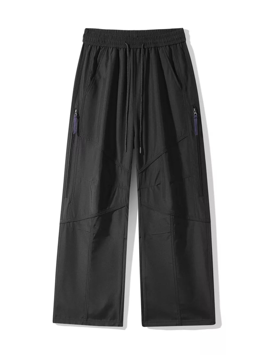 Men's black loose fit cargo pants with drawstring and zippered pockets.