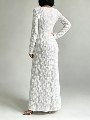 White textured long sleeve maxi dress with cutout detail and a pullover closure.