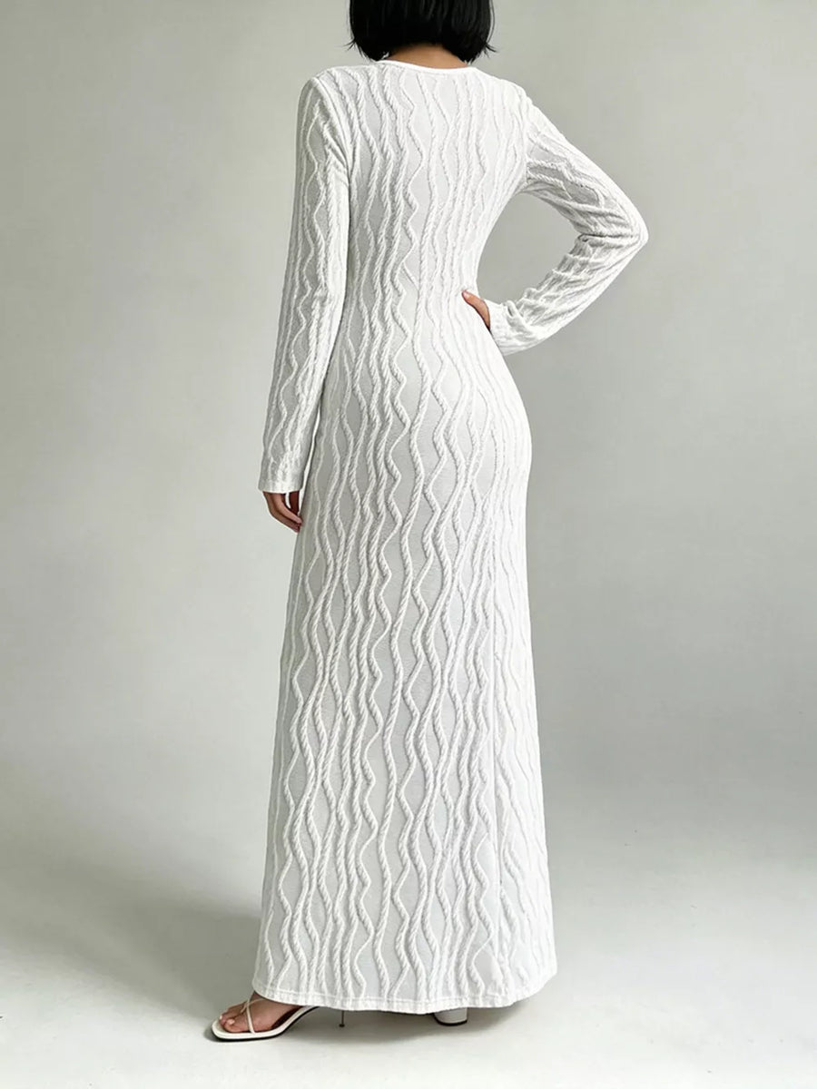 White textured long sleeve maxi dress with cutout detail and a pullover closure.